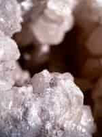 Free photo a close up of a large white quartz rock with a small black speck on the top.