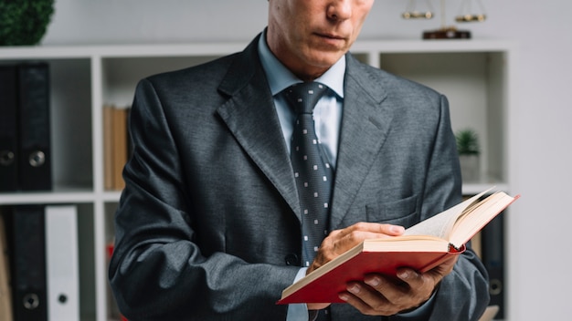 Free photo close-up of lawyer reading book in the courtroom