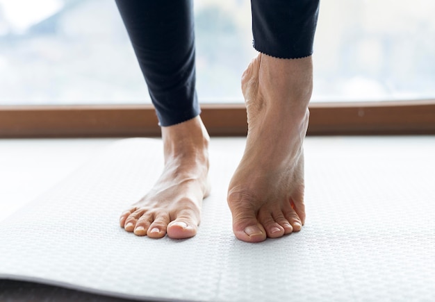 Close-up legs doing stretching exercises before workout