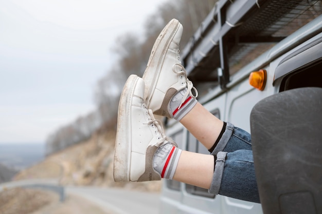 Close up legs out the car window