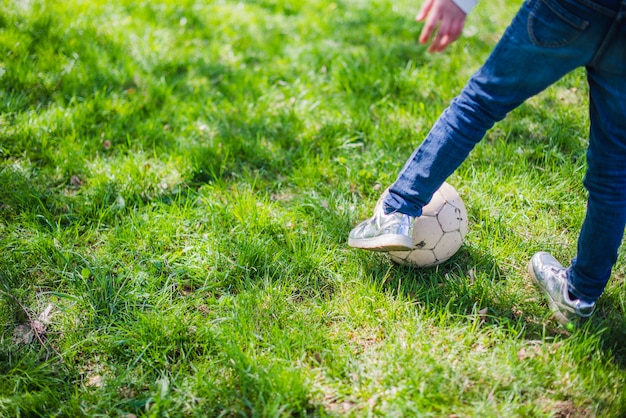 Close-up of legs playing with a ball