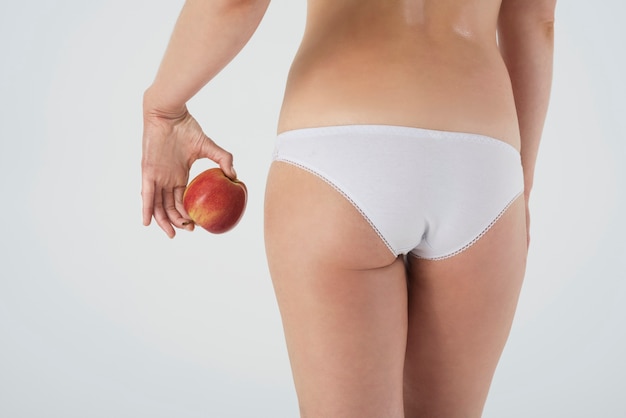 Close up on legs of woman in basic underwear isolated