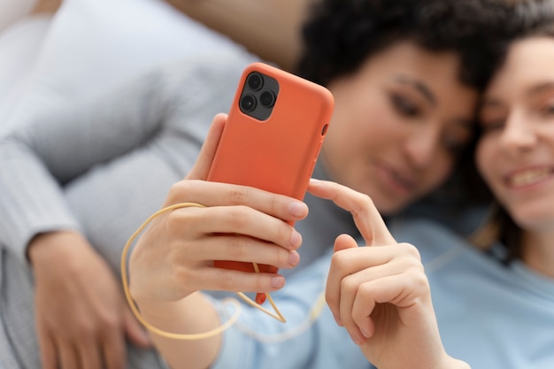 Free photo close up lesbian couple taking selfie