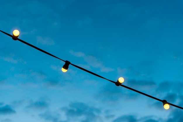 Free photo close-up of a lights string with blue sky