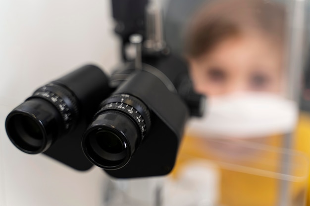 Free Photo close up little boy at eyes consult