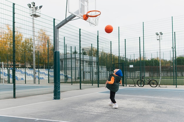 Close up on little boy playing basketball