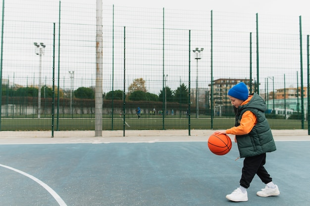 Close up on little boy playing basketball