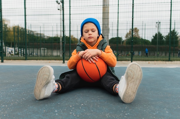 Free photo close up on little boy playing basketball