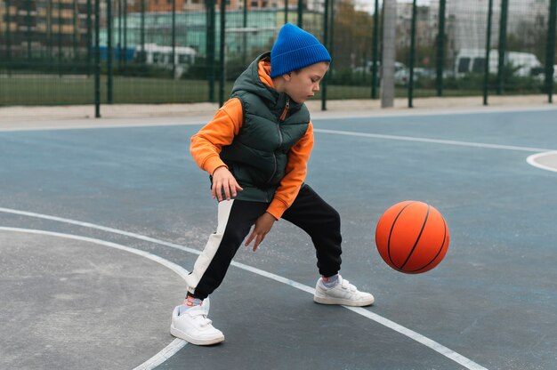 Close up on little boy playing basketball