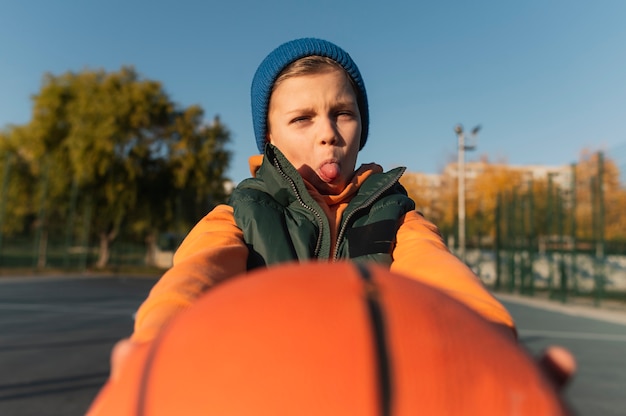 Close up on little boy playing basketball