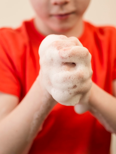 Free Photo close-up little boy with foam