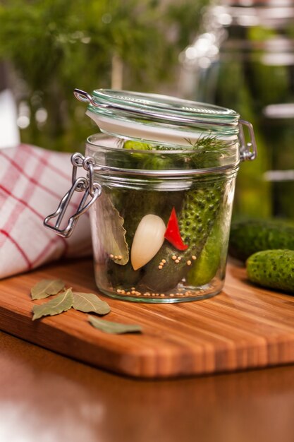 Close up of little jar with pickled cucumbers