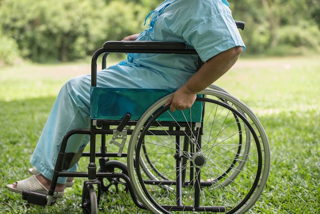 Free Photo close up lonely elderly woman sitting on wheelchair at garden in hospital