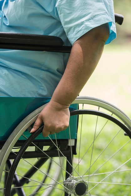 Free photo close up lonely elderly woman sitting on wheelchair at garden in hospital