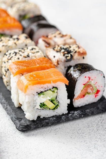 Close-up maki sushi rolls assortment on slate