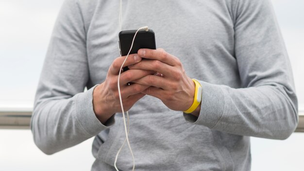 Close-up male browsing his mobile phone