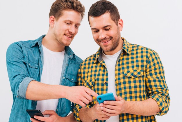 Close-up of male friend showing something on mobile phone