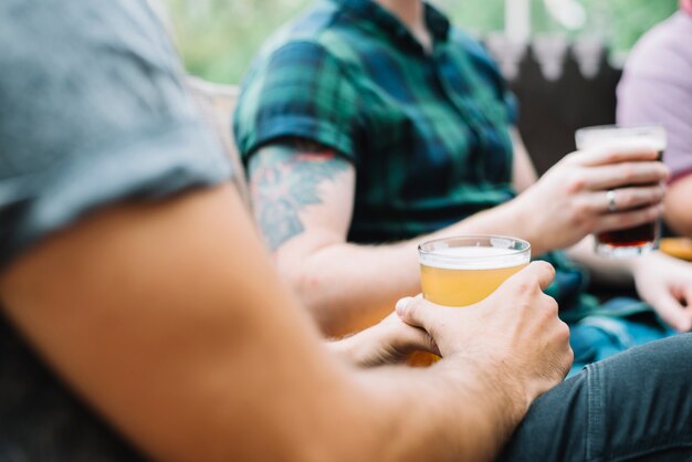 Close-up of male friends with glass of alcoholic drinks