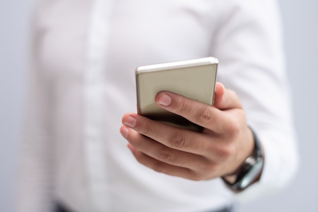 Close-up of male hand holding mobile phone