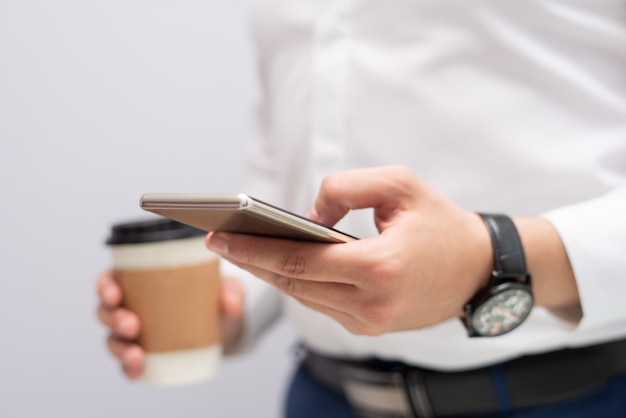 Close-up of male hand texting message on mobile phone