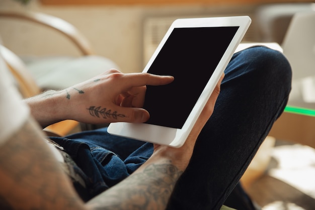 Free photo close up of male hands using tablet with blank screen, copyspace.