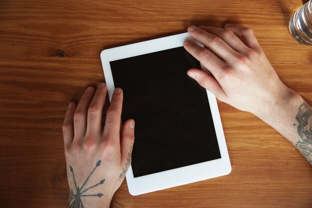 Close up of male hands using tablet with blank screen