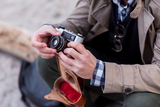 Free photo close-up of a male hiker adjusting the camera