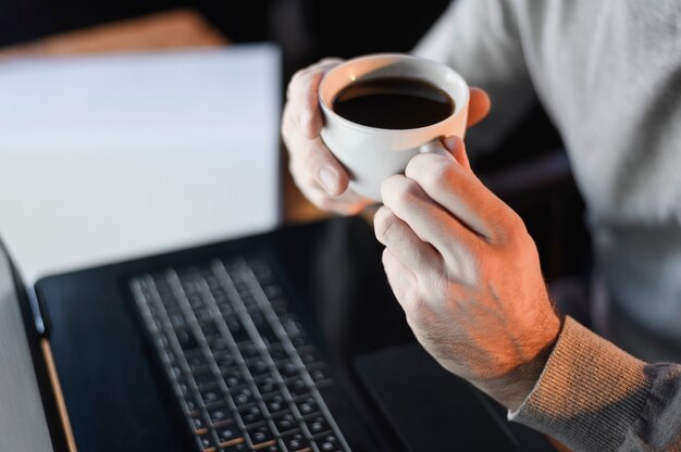 Close-up male holding coffee cup