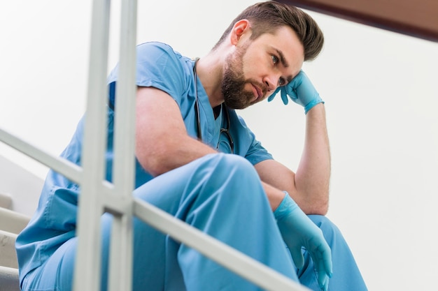 Close-up male nurse taking a break at work