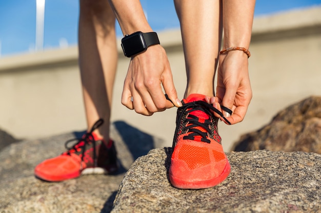 Free photo close up of a male runner tying his shoelaces