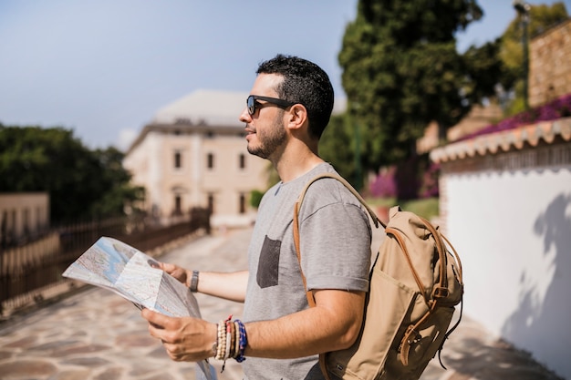 Free photo close-up of male tourist holding map in his hand