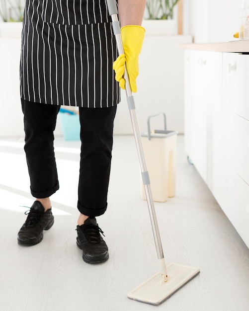 Free photo close-up male whipping floor