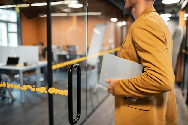 Free photo close up man carrying laptop