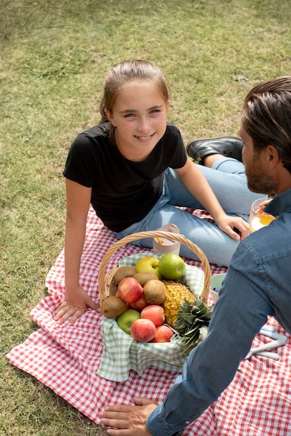 Close up man and daughter at picnic