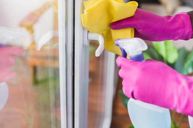 Close-up man disinfecting house