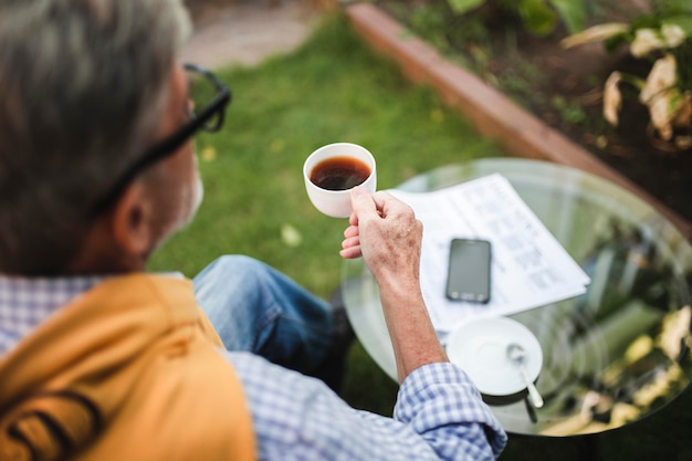 Close-up man drinking coffee outdoors