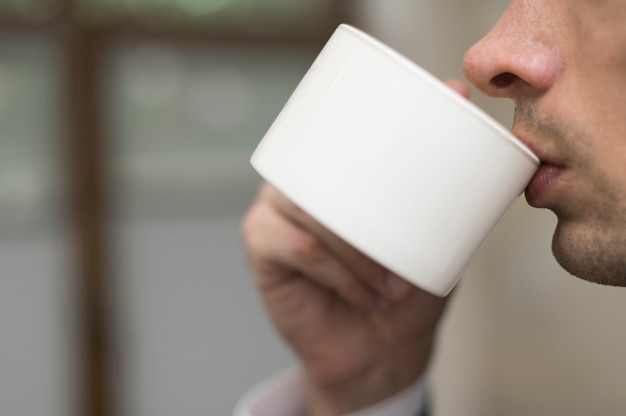 Free Photo close-up of man drinking coffee