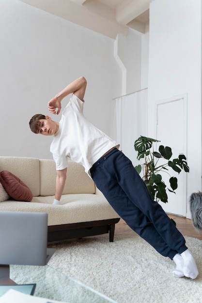 Close up on man exercising after online instructor