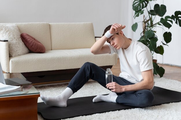 Close up on man exercising after online instructor