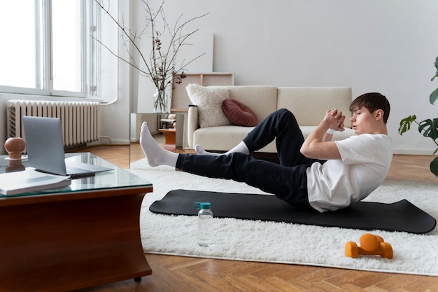 Close up on man exercising after online instructor