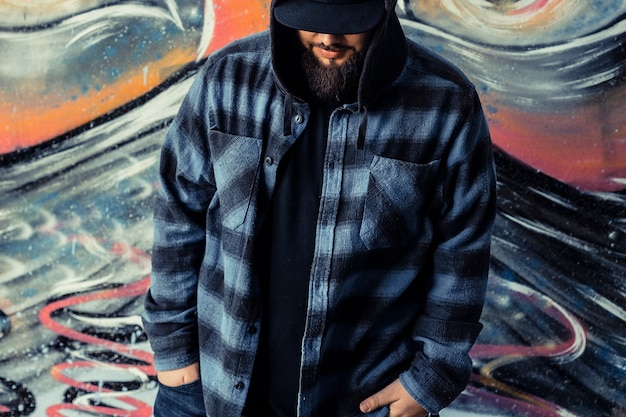 Free Photo close-up of a man in front of graffiti wall