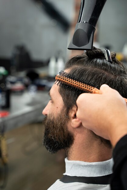 Close up man getting a haircut