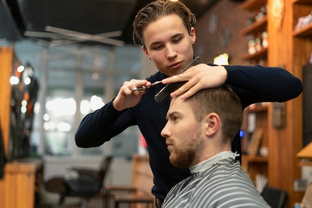 Close up man getting haircut