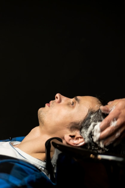 Close up man getting hairwashed with copy space