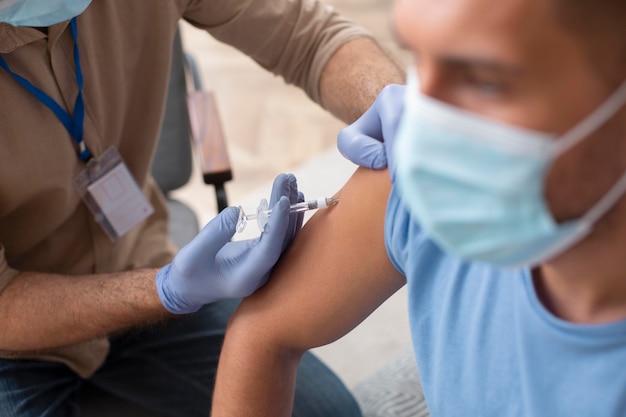 Close up man getting vaccinated