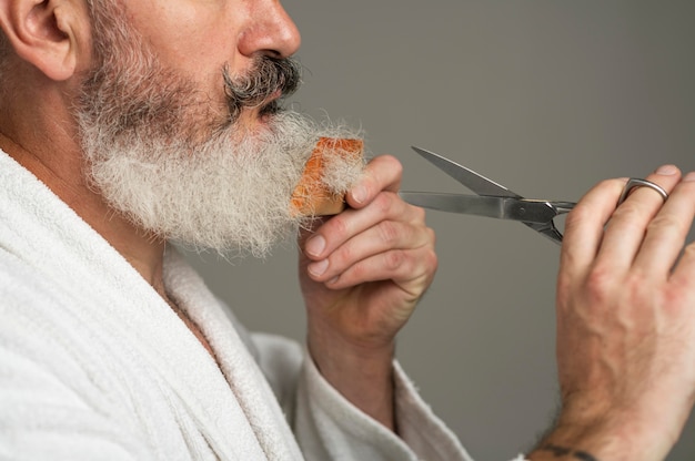 Close up man grooming beard