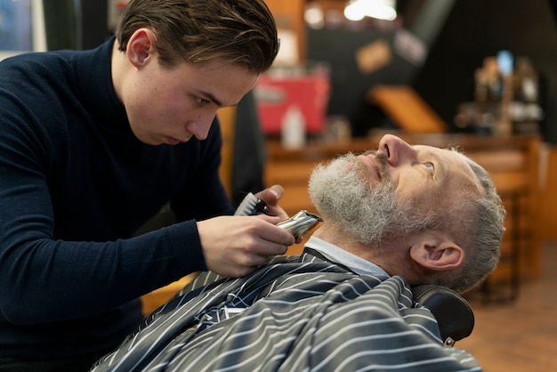 Close up man and hairstylist indoors