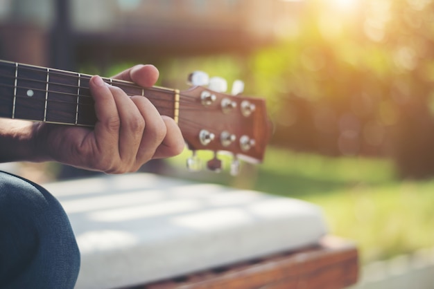 Close up of  man hand playing acoustic guitar.