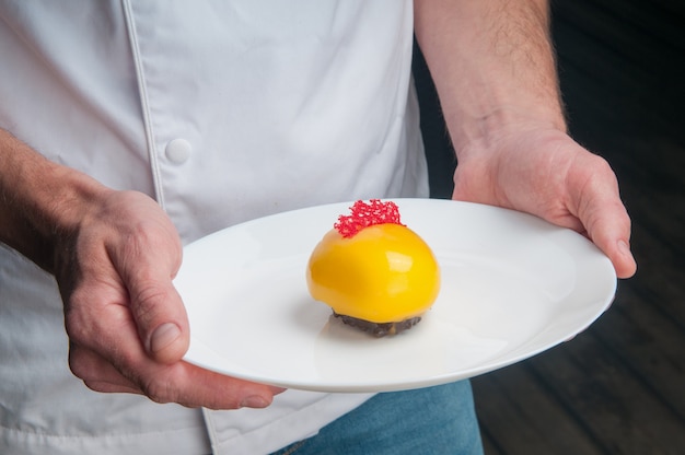 Close-up of man holding beautiful colorful dessert