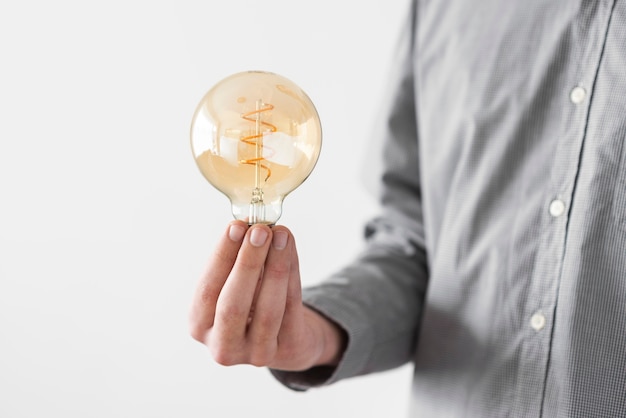 Free photo close up man holding bulb